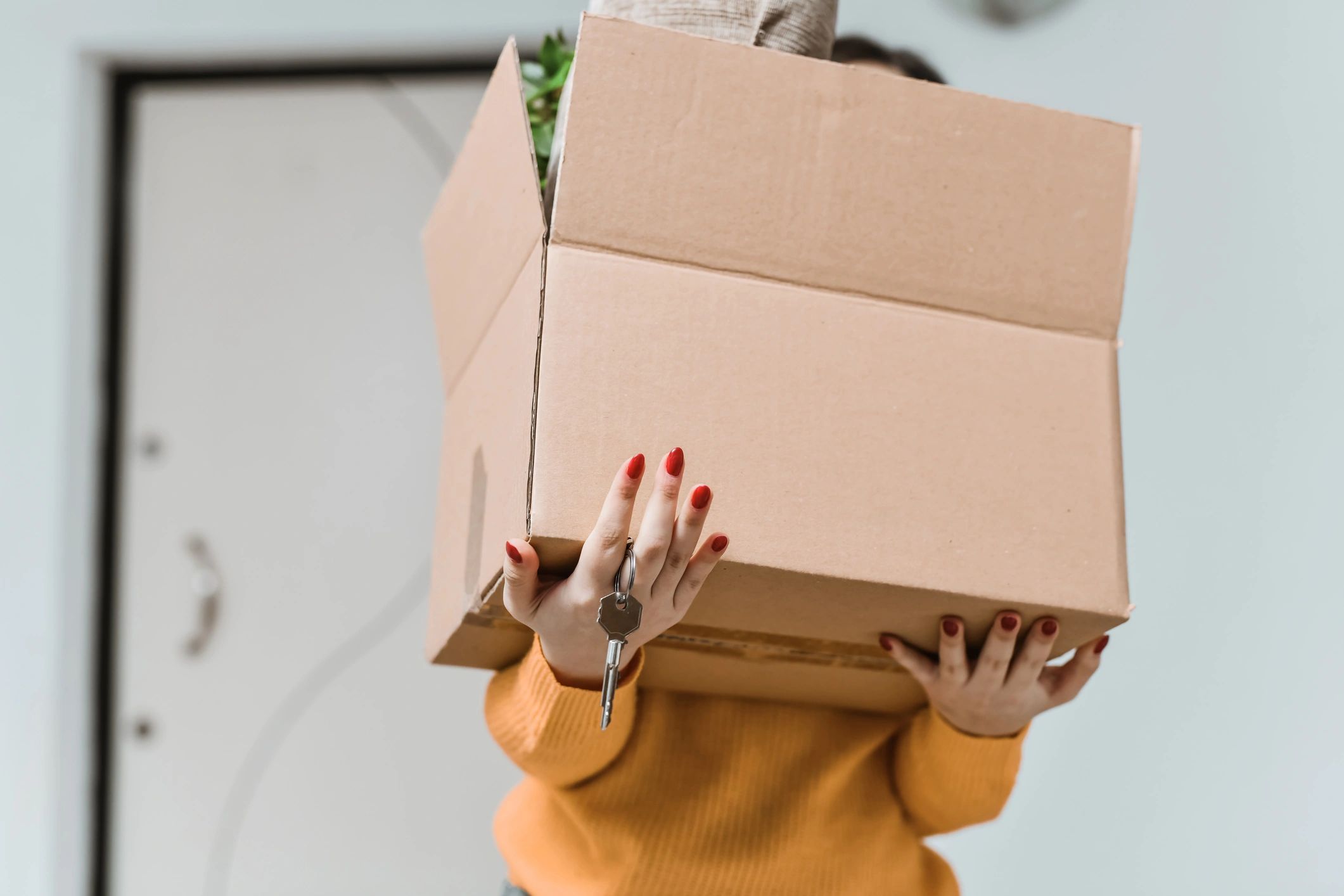 Homeowner holding a key and moving box